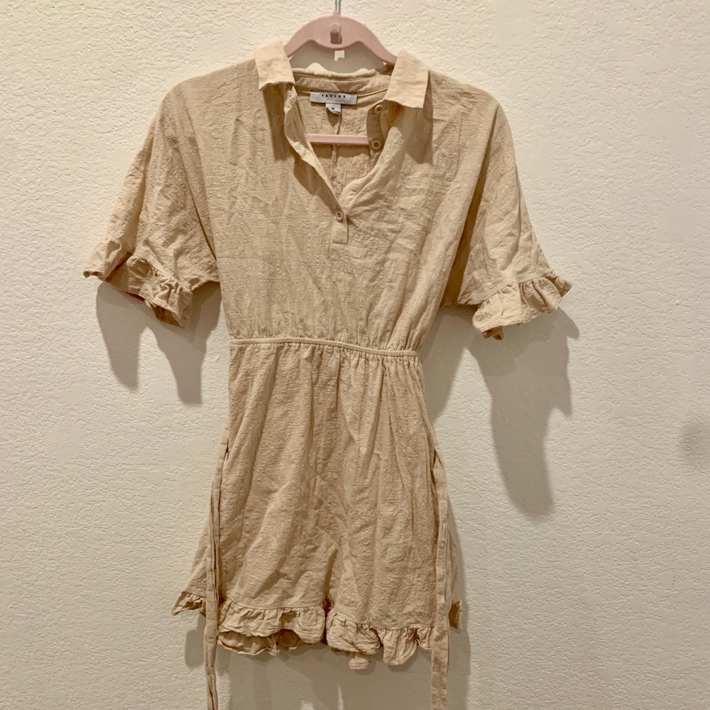 Tan mini dress with button up and collar. W/ tie and ruffles sleeves.